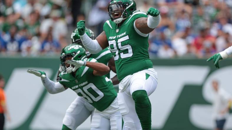 Aug 28, 2022; East Rutherford, New Jersey, USA; New York Jets defensive tackle Quinnen Williams (95) celebrates his sack with cornerback Michael Carter II (30) during the first half against the New York Giants at MetLife Stadium. Mandatory Credit: Vincent Carchietta-USA TODAY Sports