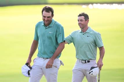 Aug 28, 2022; Atlanta, Georgia, USA; Scottie Scheffler and Rory McIlroy walk of the 18th green during the final round of the TOUR Championship golf tournament. Mandatory Credit: Adam Hagy-USA TODAY Sports