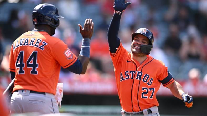 Sep 4, 2022; Anaheim, California, USA; Houston Astros second baseman Jose Altuve (27) is congratulated by left fielder Yordan Alvarez (44) after hitting a two-run home run against the Los Angeles Angels during the seventh inning at Angel Stadium. Mandatory Credit: Orlando Ramirez-USA TODAY Sports