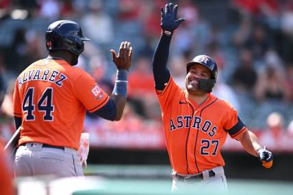Sep 4, 2022; Anaheim, California, USA; Houston Astros second baseman Jose Altuve (27) is congratulated by left fielder Yordan Alvarez (44) after hitting a two-run home run against the Los Angeles Angels during the seventh inning at Angel Stadium. Mandatory Credit: Orlando Ramirez-USA TODAY Sports