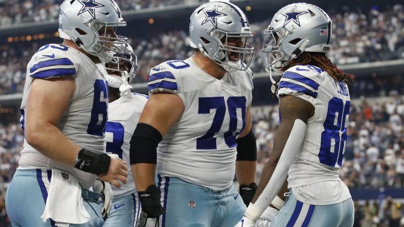 Guard Zack Martin (70) and wide receiver CeeDee Lamb (88) celebrate a touchdown in the fourth quarter against the Washington Commanders at AT&T Stadium. Mandatory Credit: Tim Heitman-USA TODAY Sports