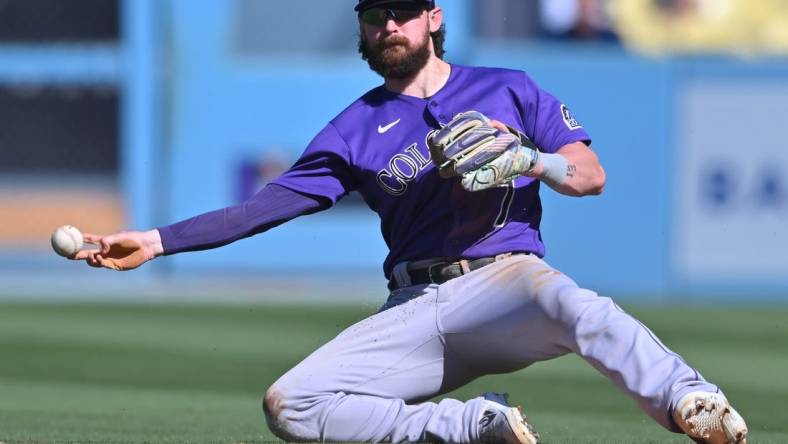 Oct 2, 2022; Los Angeles, California, USA; Colorado Rockies second baseman Brendan Rodgers (7) makes a play to throw out Los Angeles Dodgers first baseman Freddie Freeman (5) at second base in the sixth inning at Dodger Stadium. Mandatory Credit: Jayne Kamin-Oncea-USA TODAY Sports