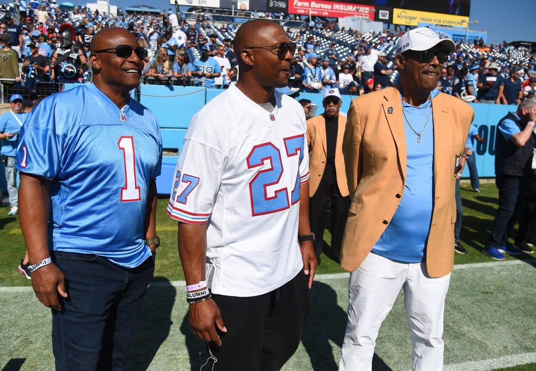 Oct 23, 2022; Nashville, Tennessee, USA; Former Houston Oilers quarterback Warren Moon (1), Tennessee Titans running back Eddie George (27) and NFL Hall of Famer Robert Brazile watch warmups before the game against the Indianapolis Colts at Nissan Stadium. Mandatory Credit: Christopher Hanewinckel-USA TODAY Sports