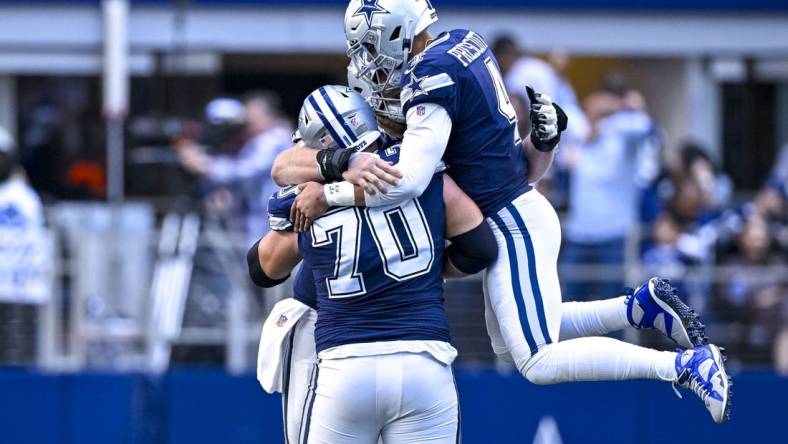 Oct 30, 2022; Arlington, Texas, USA; Dallas Cowboys quarterback Dak Prescott (4) and guard Zack Martin (70) celebrates a touchdown  scored by running back Tony Pollard (not pictured) during the second half against the Chicago Bears at AT&T Stadium. Mandatory Credit: Jerome Miron-USA TODAY Sports