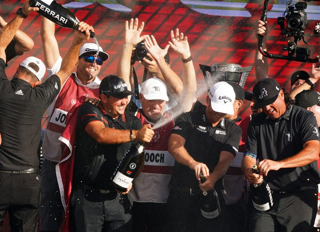 Oct 30, 2022; Miami, Florida, USA; Dustin Johnson , Patrick Reed , Talor Gooch and Pat Perez celebrates team 4Aces GC winning the season finale of the LIV Golf series at Trump National Doral. Mandatory Credit: John David Mercer-USA TODAY Sports