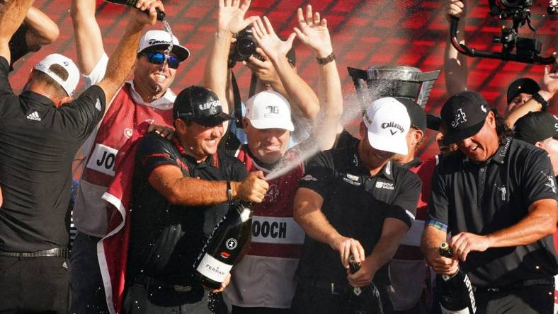 Oct 30, 2022; Miami, Florida, USA; Dustin Johnson , Patrick Reed , Talor Gooch and Pat Perez celebrates team 4Aces GC winning the season finale of the LIV Golf series at Trump National Doral. Mandatory Credit: John David Mercer-USA TODAY Sports