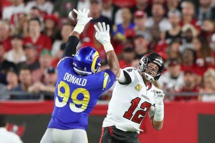 Nov 6, 2022; Tampa, Florida, USA;  Los Angeles Rams defensive tackle Aaron Donald (99) breaks up a pass by Tampa Bay Buccaneers quarterback Tom Brady (12) in the fourth quarter at Raymond James Stadium. Mandatory Credit: Nathan Ray Seebeck-USA TODAY Sports