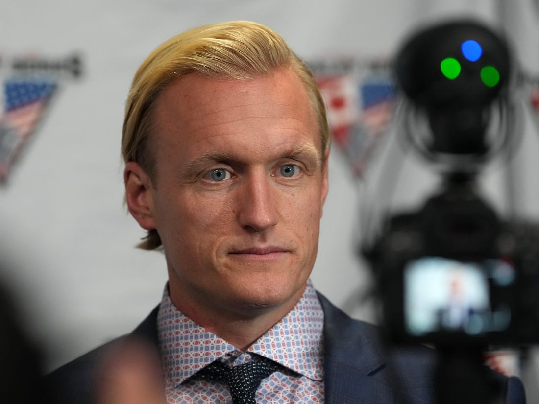 Dec 15, 2022; Henderson, Nevada, USA; Team USA head coach John Wroblewski takes questions from reporters after Team Canada defeated Team USA 3-2 in a Rivalry Series women's ice hockey game at Dollar Loan Center. Mandatory Credit: Stephen R. Sylvanie-USA TODAY Sports