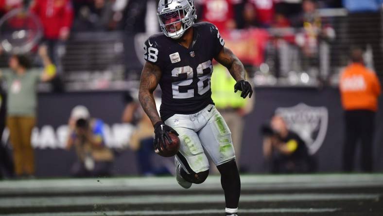 January 1, 2023; Paradise, Nevada, USA; Las Vegas Raiders running back Josh Jacobs (28) scores a touchdown against the San Francisco 49ers during the second half at Allegiant Stadium. Mandatory Credit: Gary A. Vasquez-USA TODAY Sports