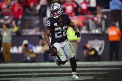 January 1, 2023; Paradise, Nevada, USA; Las Vegas Raiders running back Josh Jacobs (28) scores a touchdown against the San Francisco 49ers during the second half at Allegiant Stadium. Mandatory Credit: Gary A. Vasquez-USA TODAY Sports
