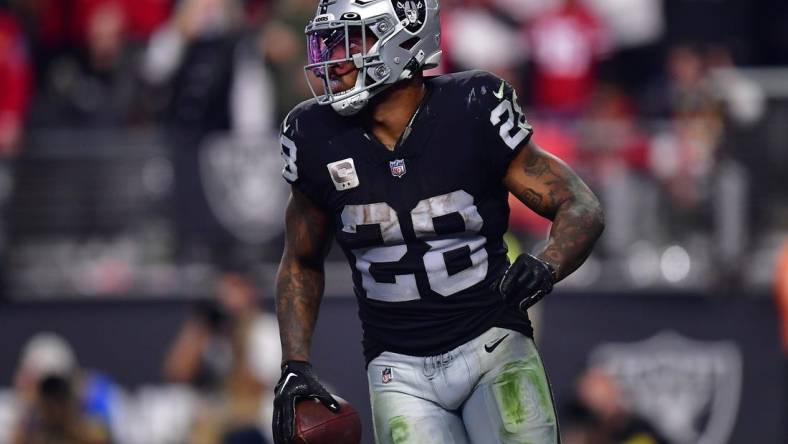 January 1, 2023; Paradise, Nevada, USA; Las Vegas Raiders running back Josh Jacobs (28) scores a touchdown against the San Francisco 49ers during the second half at Allegiant Stadium. Mandatory Credit: Gary A. Vasquez-USA TODAY Sports