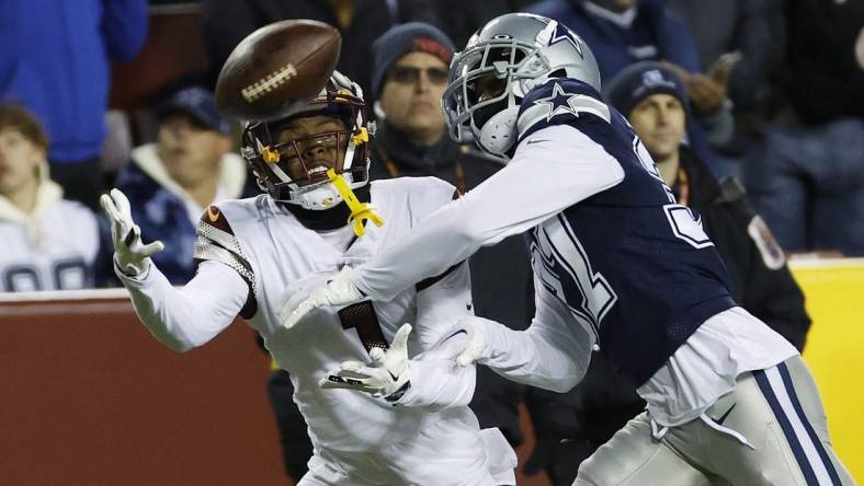 Jan 8, 2023; Landover, Maryland, USA; Washington Commanders wide receiver Jahan Dotson (1) attempts to catch a pass as Dallas Cowboys cornerback Trayvon Mullen (37) defends during the third quarter at FedExField. Mandatory Credit: Geoff Burke-USA TODAY Sports