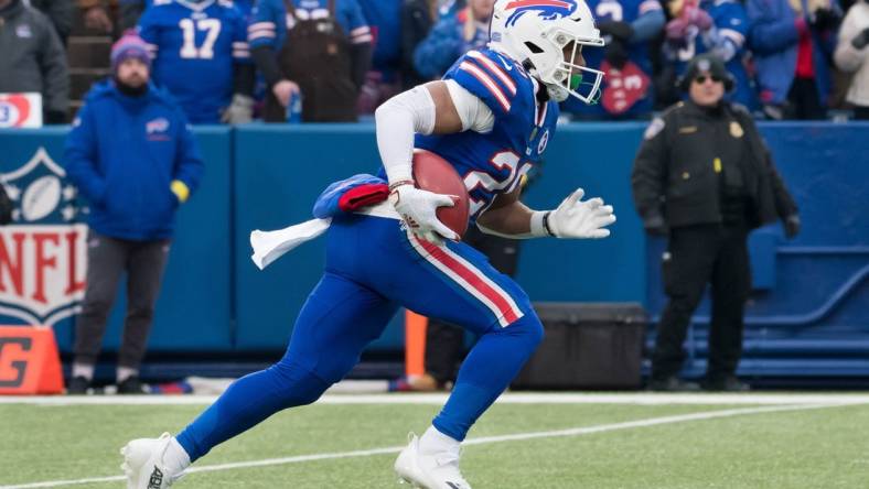 Jan 8, 2023; Orchard Park, New York, USA; Buffalo Bills running back Nyheim Hines (20) returns a kickoff to score a touchdown on the opening play of a game against the New England Patriots at Highmark Stadium. Mandatory Credit: Mark Konezny-USA TODAY Sports