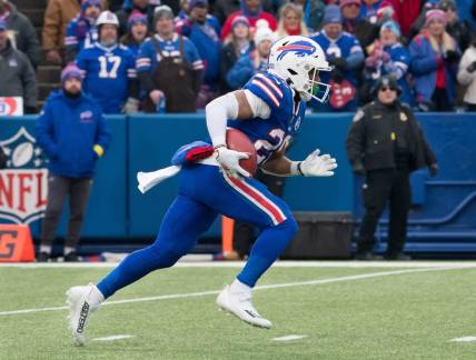 Jan 8, 2023; Orchard Park, New York, USA; Buffalo Bills running back Nyheim Hines (20) returns a kickoff to score a touchdown on the opening play of a game against the New England Patriots at Highmark Stadium. Mandatory Credit: Mark Konezny-USA TODAY Sports