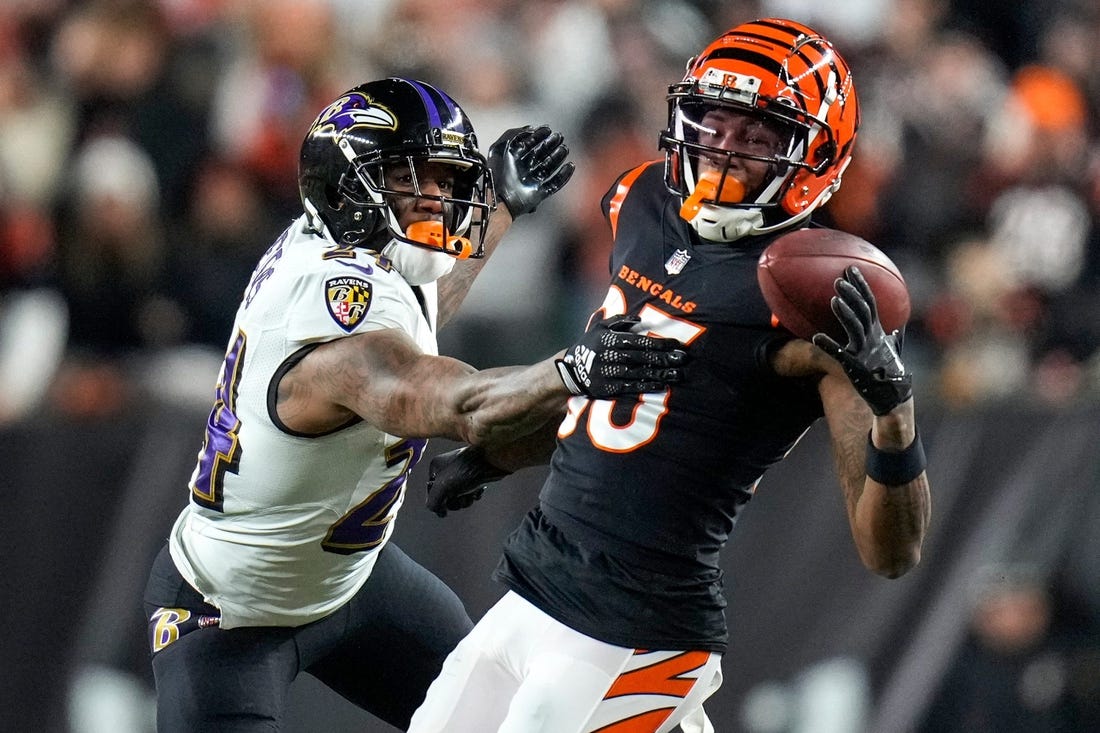 Cincinnati Bengals wide receiver Tee Higgins (85) is unable to hold onto a pass under pressure from Baltimore Ravens cornerback Marcus Peters (24) in the third quarter during an NFL wild-card playoff football game between the Baltimore Ravens and the Cincinnati Bengals, Sunday, Jan. 15, 2023, at Paycor Stadium in Cincinnati. The Bengals advanced to the Divisional round of the playoffs with a 24-17 win over the Ravens. Baltimore Ravens At Cincinnati Bengals. © Sam Greene/The Enquirer / USA TODAY NETWORK