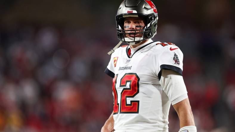 Jan 16, 2023; Tampa, Florida, USA; Tampa Bay Buccaneers quarterback Tom Brady (12) looks on before a  wild card game against the Dallas Cowboys at Raymond James Stadium. Mandatory Credit: Nathan Ray Seebeck-USA TODAY Sports