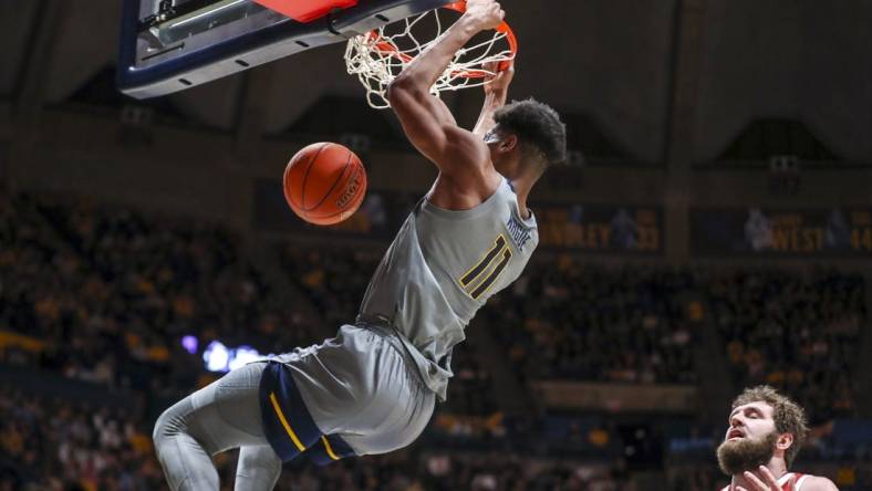 Feb 4, 2023; Morgantown, West Virginia, USA; West Virginia Mountaineers forward Mohamed Wague (11) dunks the ball during the second half against the Oklahoma Sooners at WVU Coliseum. Mandatory Credit: Ben Queen-USA TODAY Sports