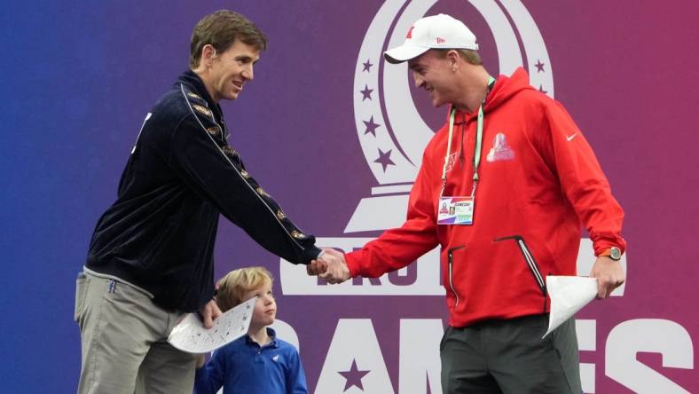 Feb 5, 2023; Paradise, Nevada, USA; NFC captain Eli Manning (left) and AFC captain Peyton Manning shake hands during the Pro Bowl Games at Allegiant Stadium. Mandatory Credit: Kirby Lee-USA TODAY Sports