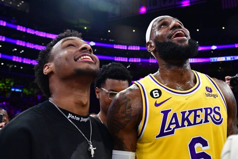 Feb 7, 2023; Los Angeles, California, USA; Los Angeles Lakers forward LeBron James (6) celebrates with his son Bronny James after breaking the all-time scoring record in the third quarter against the Oklahoma City Thunder at Crypto.com Arena. Mandatory Credit: Gary A. Vasquez-USA TODAY Sports