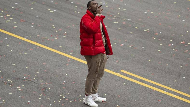 Feb 15, 2023; Kansas City, MO, USA; Kansas City Chiefs defensive tackle Chris Jones smokes a cigar at the Super Bowl LVII Champions Parade in downtown Kansas City, Mo. Mandatory Credit: Amy Kontras-USA TODAY Sports