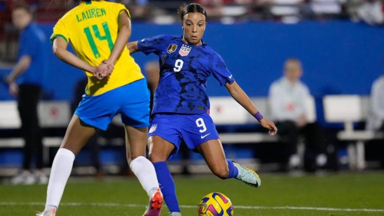 Feb 22, 2023; Frisco, Texas, USA; United States forward Mallory Swanson (9) passes the ball as Brazil defender Lauren (14) defends during the first half at Toyota Stadium. Mandatory Credit: Chris Jones-USA TODAY Sports