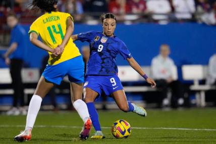 Feb 22, 2023; Frisco, Texas, USA; United States forward Mallory Swanson (9) passes the ball as Brazil defender Lauren (14) defends during the first half at Toyota Stadium. Mandatory Credit: Chris Jones-USA TODAY Sports