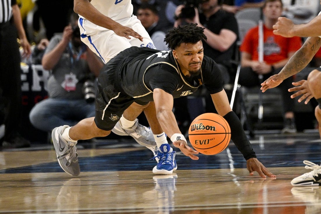 Mar 10, 2023; Fort Worth, TX, USA; UCF Knights guard Ithiel Horton (12) dives for the ball during the second half against the Memphis Tigers at Dickies Arena. Mandatory Credit: Jerome Miron-USA TODAY Sports