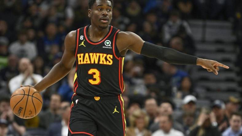 Mar 22, 2023; Minneapolis, Minnesota, USA;  Atlanta Hawks guard Aaron Holiday (3) directs traffic as he controls the ball against the Minnesota Timberwolves in the first quarter at Target Center. Mandatory Credit: Nick Wosika-USA TODAY Sports