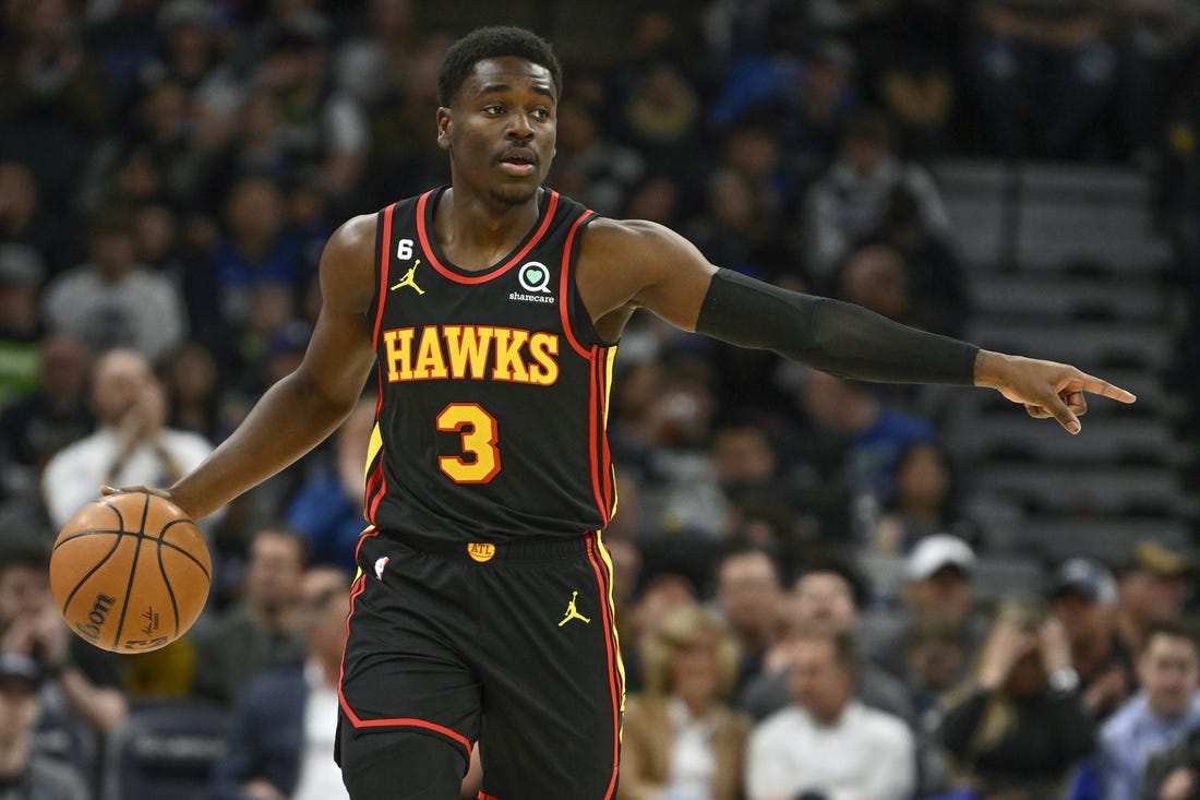 Mar 22, 2023; Minneapolis, Minnesota, USA;  Atlanta Hawks guard Aaron Holiday (3) directs traffic as he controls the ball against the Minnesota Timberwolves in the first quarter at Target Center. Mandatory Credit: Nick Wosika-USA TODAY Sports
