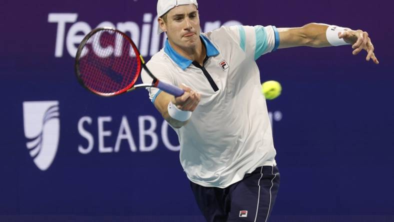 Mar 22, 2023; Miami, Florida, US; John Isner (USA) hits a forehand against Emilio Nara (USA) (not pictured) on day three of the Miami Open at Hard Rock Stadium. Mandatory Credit: Geoff Burke-USA TODAY Sports