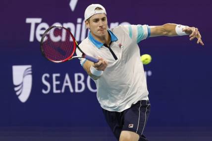 Mar 22, 2023; Miami, Florida, US; John Isner (USA) hits a forehand against Emilio Nara (USA) (not pictured) on day three of the Miami Open at Hard Rock Stadium. Mandatory Credit: Geoff Burke-USA TODAY Sports