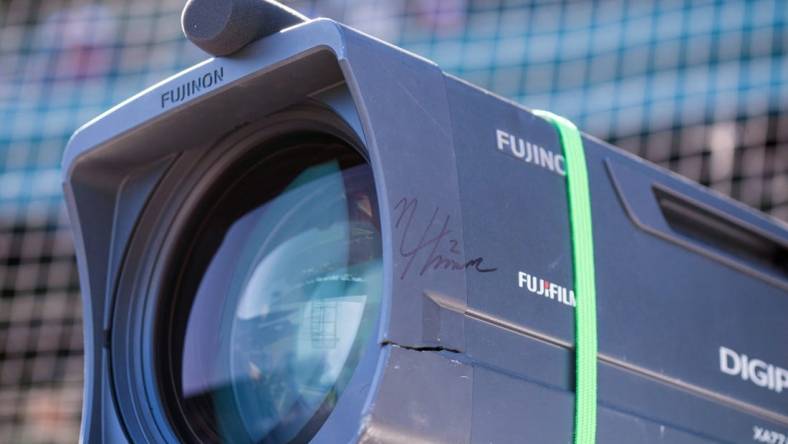 Mar 26, 2023; Mesa, Arizona, USA; A detailed view of a cracked TV camera signed by Chicago Cubs infielder Nico Hoerner (2) after a foul ball he hit hit the camera during a spring training game against the Kansas City Royals at Sloan Park. Mandatory Credit: Allan Henry-USA TODAY Sports