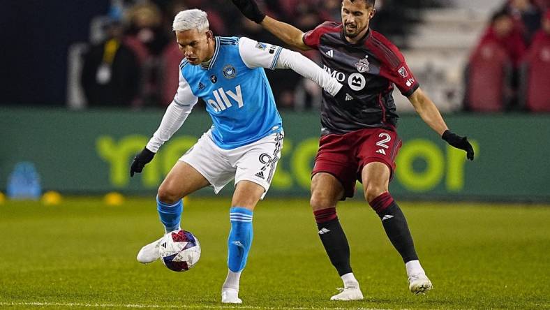 Apr 1, 2023; Toronto, Ontario, CAN; Charlotte FC forward Enzo Copetti (9) tries to control the ball against Toronto FC defender Matt Hedges (2) during the first half at BMO Field. Mandatory Credit: John E. Sokolowski-USA TODAY Sports