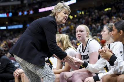 Apr 2, 2023; Dallas, TX, USA; Iowa Hawkeyes head coach Lisa Bluder talks to players on her bench in the game against the LSU Lady Tigers in the second half during the final round of the Women's Final Four NCAA tournament at the American Airlines Center. Mandatory Credit: Kevin Jairaj-USA TODAY Sports