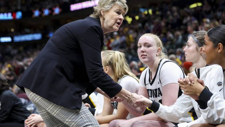 Apr 2, 2023; Dallas, TX, USA; Iowa Hawkeyes head coach Lisa Bluder talks to players on her bench in the game against the LSU Lady Tigers in the second half during the final round of the Women's Final Four NCAA tournament at the American Airlines Center. Mandatory Credit: Kevin Jairaj-USA TODAY Sports