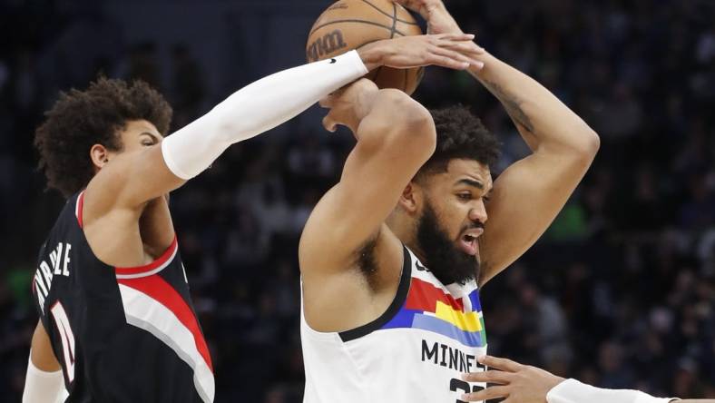 Apr 2, 2023; Minneapolis, Minnesota, USA; Portland Trail Blazers forward Matisse Thybulle (4) tries to strip the ball from Minnesota Timberwolves center Karl-Anthony Towns (32) in the third quarter at Target Center. Mandatory Credit: Bruce Kluckhohn-USA TODAY Sports