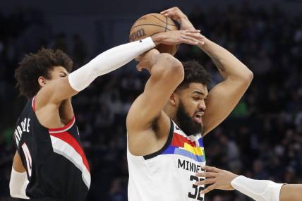 Apr 2, 2023; Minneapolis, Minnesota, USA; Portland Trail Blazers forward Matisse Thybulle (4) tries to strip the ball from Minnesota Timberwolves center Karl-Anthony Towns (32) in the third quarter at Target Center. Mandatory Credit: Bruce Kluckhohn-USA TODAY Sports