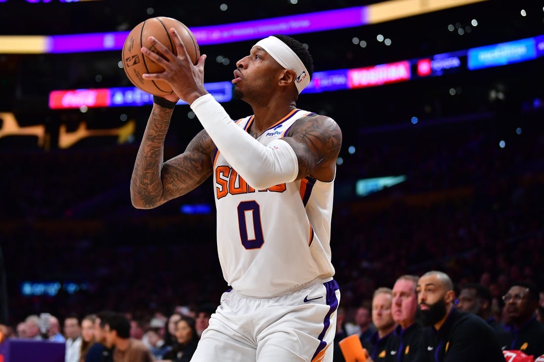 Apr 7, 2023; Los Angeles, California, USA; Phoenix Suns forward Torrey Craig (0) shoots against the Los Angeles Lakers during the second half at Crypto.com Arena. Mandatory Credit: Gary A. Vasquez-USA TODAY Sports