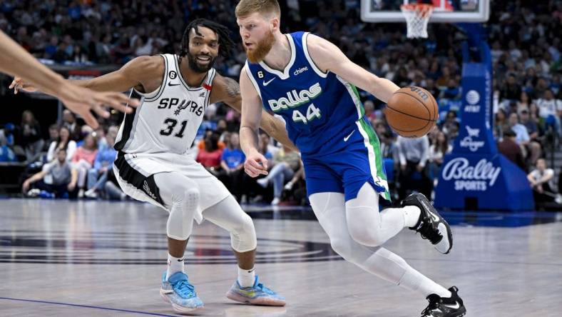 Apr 9, 2023; Dallas, Texas, USA; Dallas Mavericks forward Davis Bertans (44) drives to the basket past San Antonio Spurs forward Keita Bates-Diop (31) during the second quarter at the American Airlines Center. Mandatory Credit: Jerome Miron-USA TODAY Sports