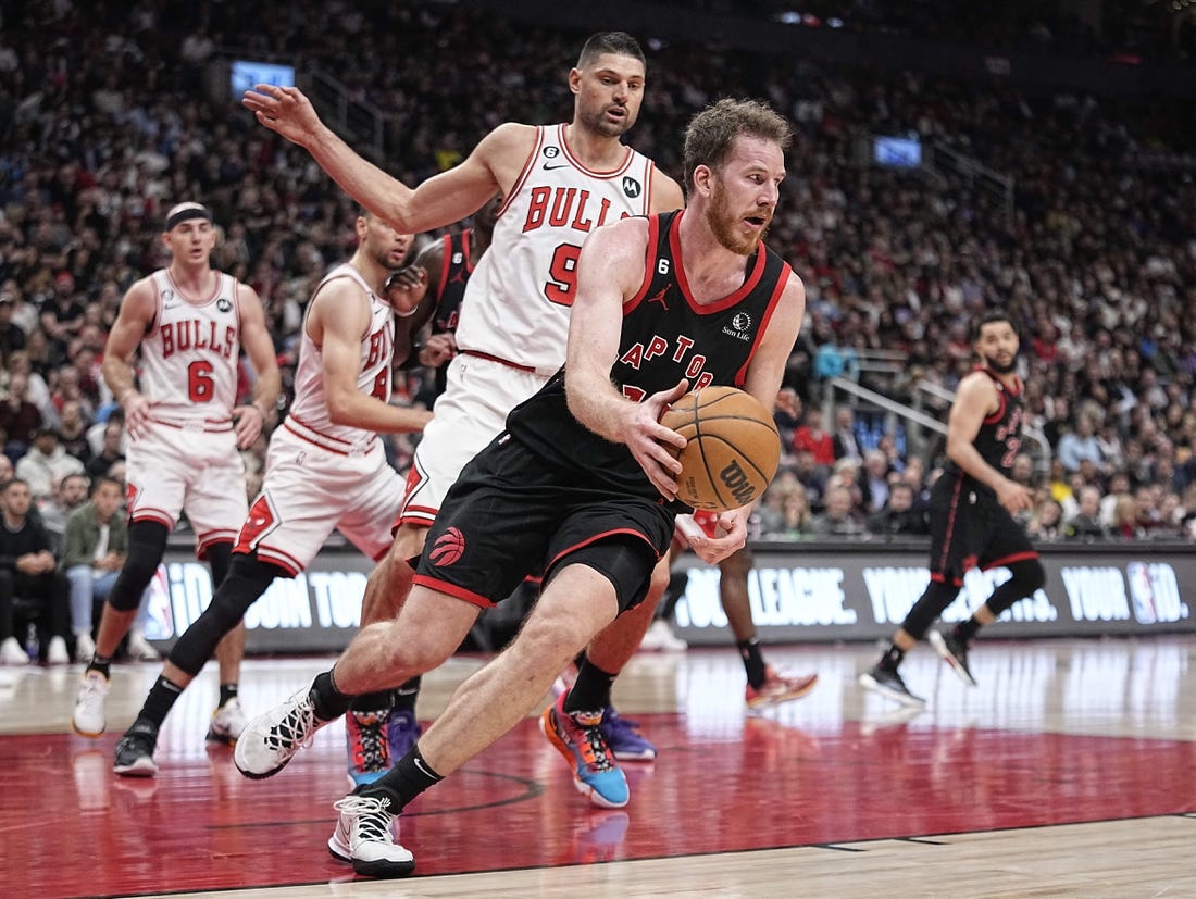 Apr 12, 2023; Toronto, Ontario, CAN; Toronto Raptors center Jakob Poeltl (19) recovers a loose ball against Chicago Bulls center Nikola Vucevic (9) during the second half of a NBA Play-In game at Scotiabank Arena. Mandatory Credit: John E. Sokolowski-USA TODAY Sports