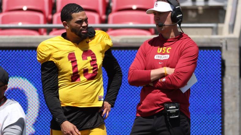 Apr 15, 2023; Los Angeles, CA, USA;  USC Trojans quarterback Caleb Williams (13) and head coach Lincoln Riley watch the game from the sideline during the Spring Game at Los Angeles Memorial Coliseum. Mandatory Credit: Kiyoshi Mio-USA TODAY Sports