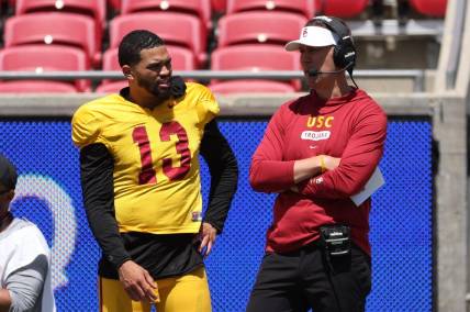 Apr 15, 2023; Los Angeles, CA, USA;  USC Trojans quarterback Caleb Williams (13) and head coach Lincoln Riley watch the game from the sideline during the Spring Game at Los Angeles Memorial Coliseum. Mandatory Credit: Kiyoshi Mio-USA TODAY Sports