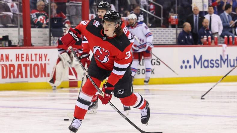 Apr 20, 2023; Newark, New Jersey, USA; New Jersey Devils defenseman Ryan Graves (33) shoots the puck during warmups against the New York Rangers before game two of the first round of the 2023 Stanley Cup Playoffs at Prudential Center. Mandatory Credit: Ed Mulholland-USA TODAY Sports