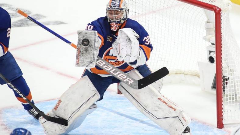 Apr 28, 2023; Elmont, New York, USA; New York Islanders goaltender Ilya Sorokin (30) stops the puck in game six of the first round of the 2023 Stanley Cup Playoffs against the Carolina Hurricanes at UBS Arena. Mandatory Credit: Wendell Cruz-USA TODAY Sports