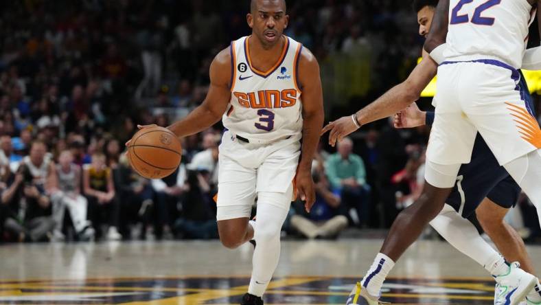 May 1, 2023; Denver, Colorado, USA; Phoenix Suns guard Chris Paul (3) controls the ball in the first quarter against the Denver Nuggets during game two of the 2023 NBA playoffs at Ball Arena. Mandatory Credit: Ron Chenoy-USA TODAY Sports