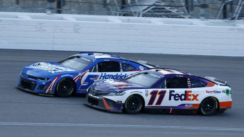 May 7, 2023; Kansas City, Kansas, USA; NASCAR Cup Series driver Denny Hamlin (11) attempts to take the lead from driver Kyle Larson (5) during the AdventHealth 400 at Kansas Speedway. Mandatory Credit: Mike Dinovo-USA TODAY Sports