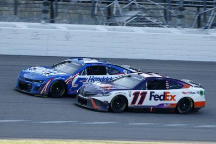 May 7, 2023; Kansas City, Kansas, USA; NASCAR Cup Series driver Denny Hamlin (11) attempts to take the lead from driver Kyle Larson (5) during the AdventHealth 400 at Kansas Speedway. Mandatory Credit: Mike Dinovo-USA TODAY Sports
