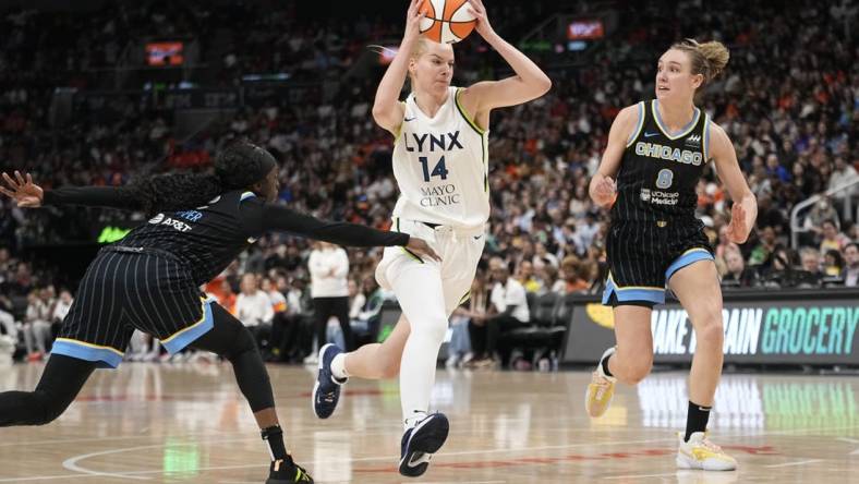 May 13, 2023; Toronto, Ontario, Canada; Minnesota Lynx forward Dorka Juhasz (14) drives past Chicago Sky guard Kahleah Copper (2) and forward Alanna Smith (8) during the second half at Scotiabank Arena. Mandatory Credit: John E. Sokolowski-USA TODAY Sports