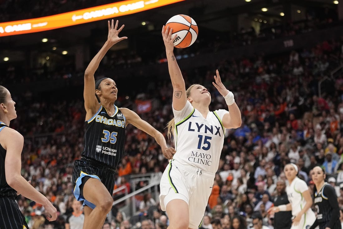 May 13, 2023; Toronto, Ontario, Canada; Minnesota Lynx guard Rachel Banham (15) goes up to make a basket as Chicago Sky guard Rebekah Gardner (35) pursues during the second half at Scotiabank Arena. Mandatory Credit: John E. Sokolowski-USA TODAY Sports