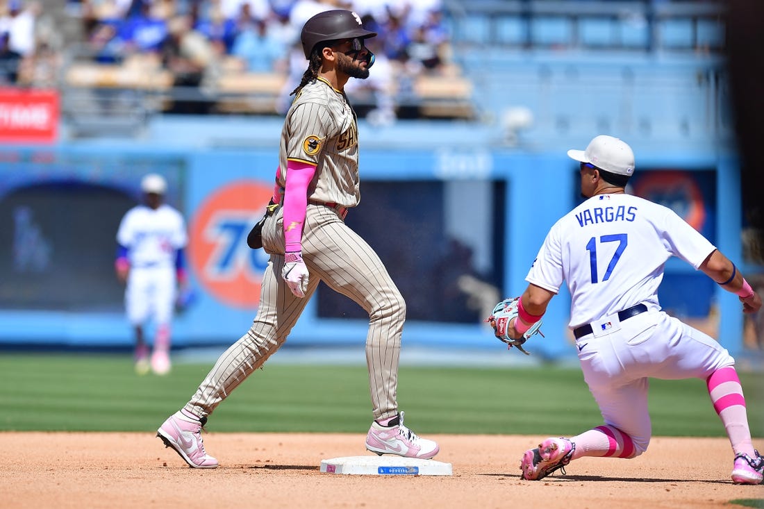 May 14, 2023; Los Angeles, California, USA; San Diego Padres right fielder Fernando Tatis Jr. (23) steals second against Los Angeles Dodgers second baseman Miguel Vargas (17) during the eighth inning at Dodger Stadium. Mandatory Credit: Gary A. Vasquez-USA TODAY Sports